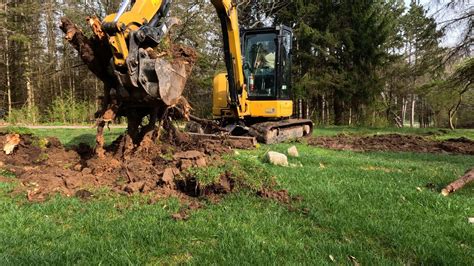 using a mini excavator remove big stumps|pulling out stumps with excavator.